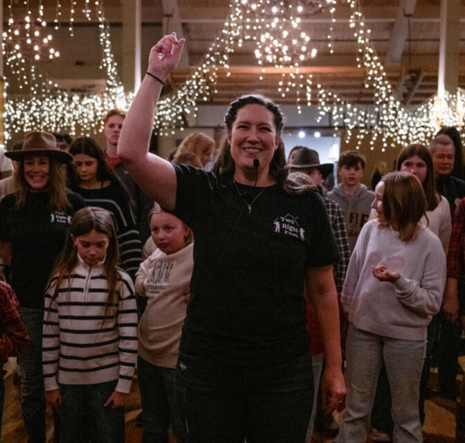 Kelly teaches a line dance to a packed floor of children and adults at Steamboat Resort's Western BBQ.